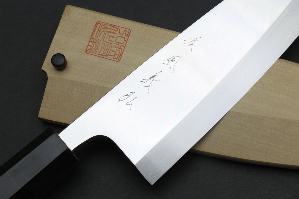 Deba sushi fillet knife with mirror blade markings and light wooden saya