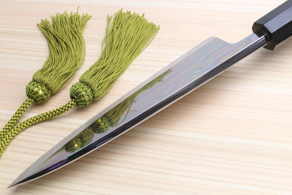 Deba sushi fillet knife with mirror blade and green braided cord tied near handle