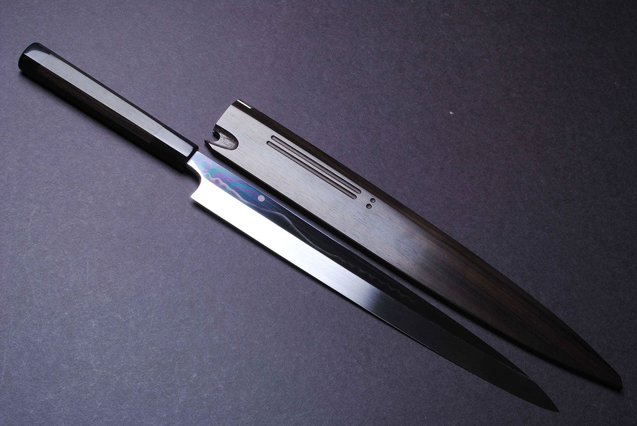 Mirror-finished steel Japanese knife with dark handle, slim blade