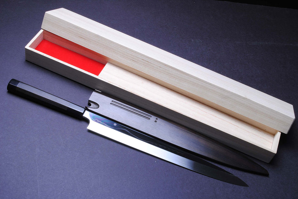Mirror-finished steel Japanese knife in light wooden box with red insert