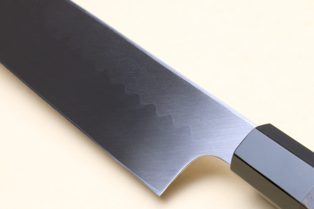 Japanese vegetable knife with mirror-finished blade and black handle detail