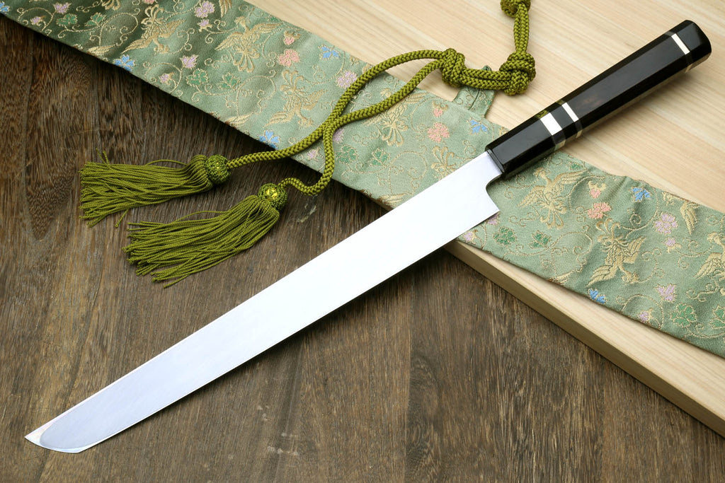 Japanese sashimi knife with long silver blade and black handle with checkered accents