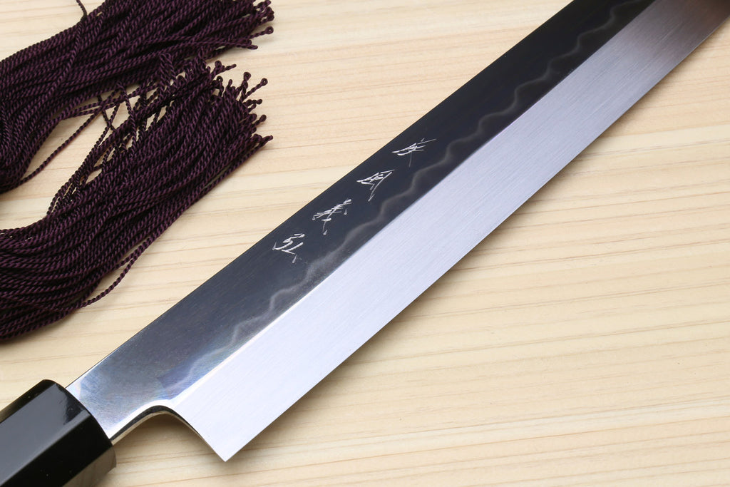 Yoshihiro Japanese sushi knife blade close-up, mirror silver finish, ebony handle