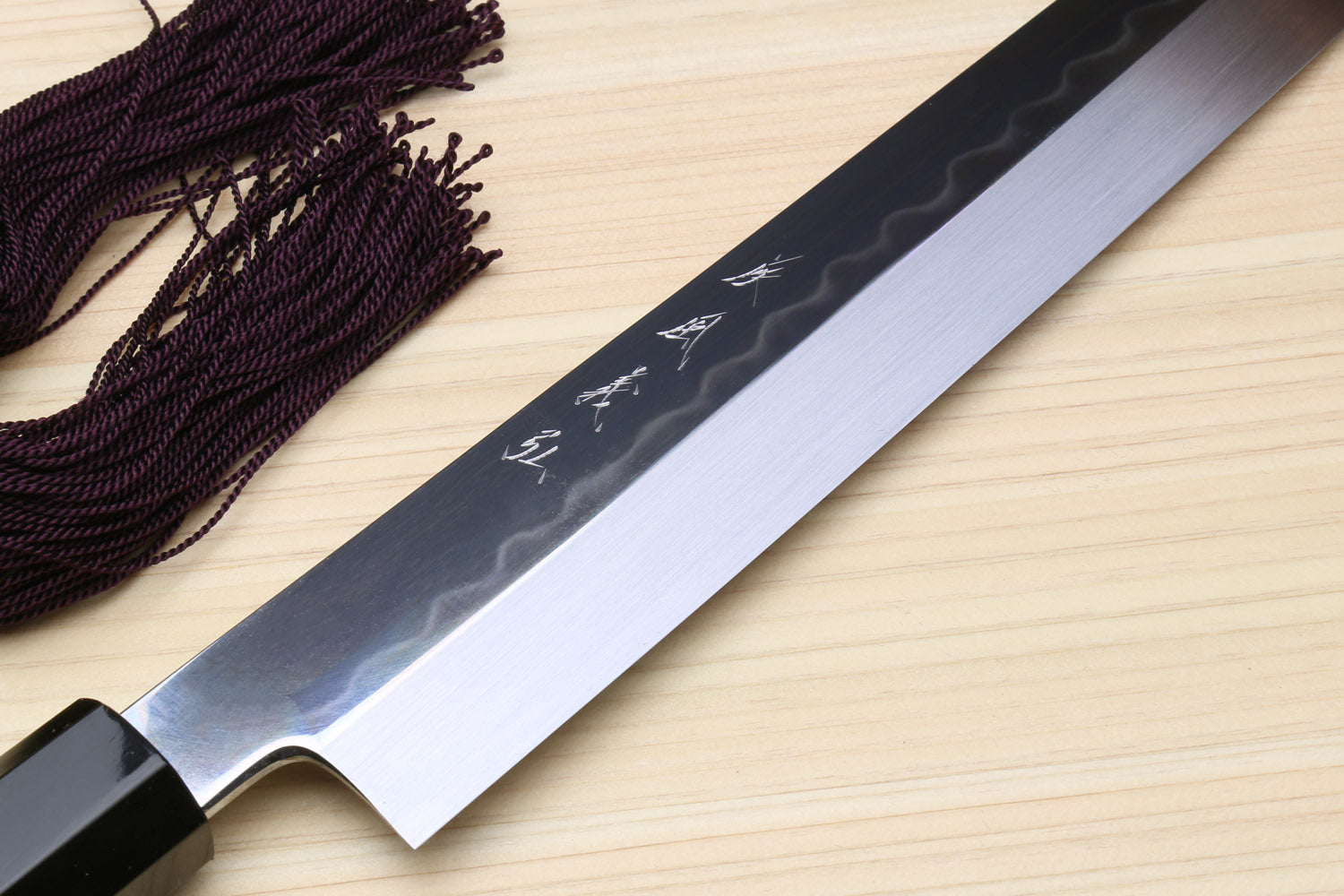Yoshihiro Japanese sushi knife blade close-up, mirror silver finish, ebony handle