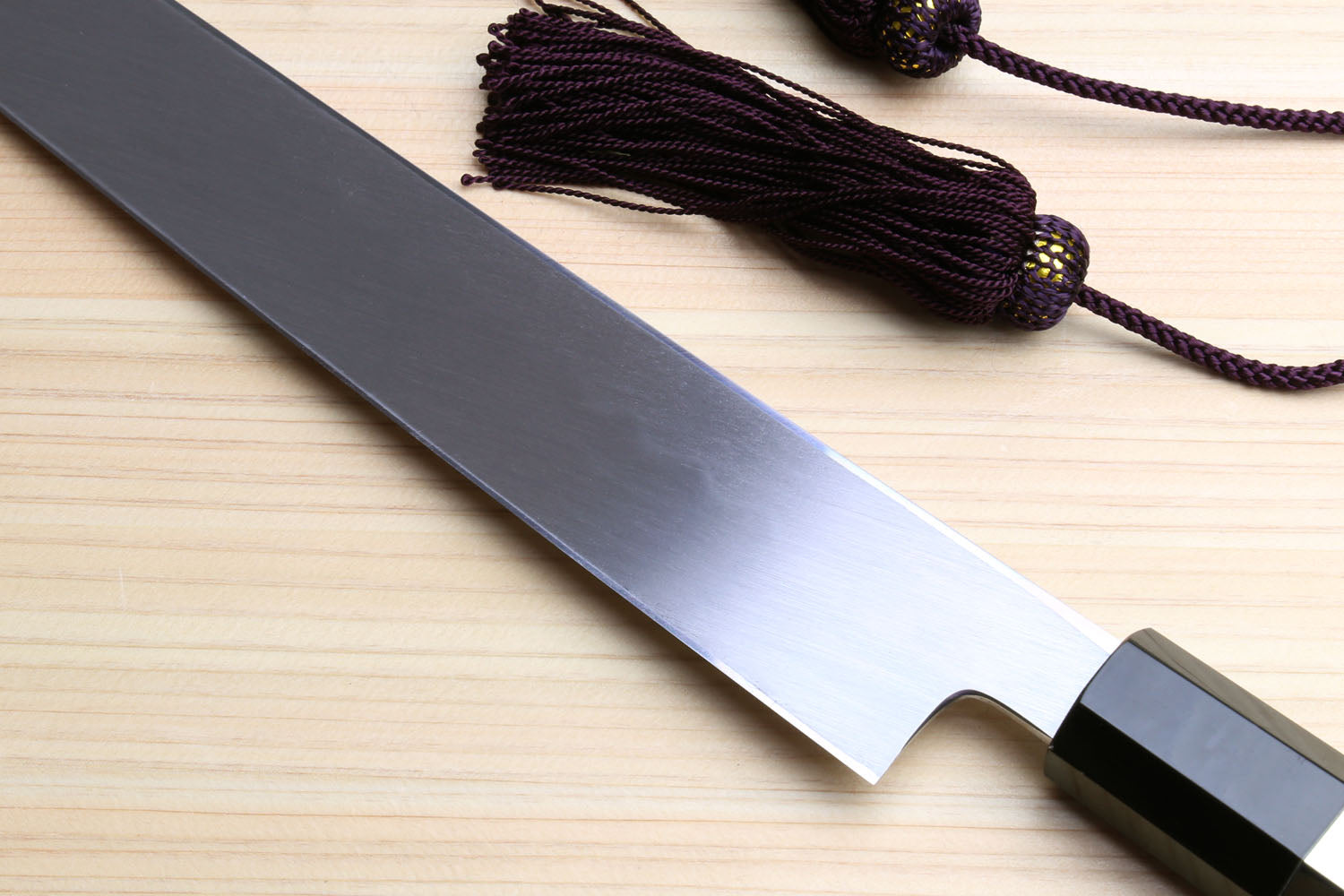 Yoshihiro Japanese sushi knife with mirror blade and striped ebony handle end caps