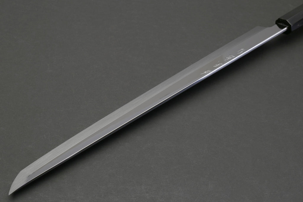 Japanese sushi knife side view with mirror-finished blade and dark ebony handle.