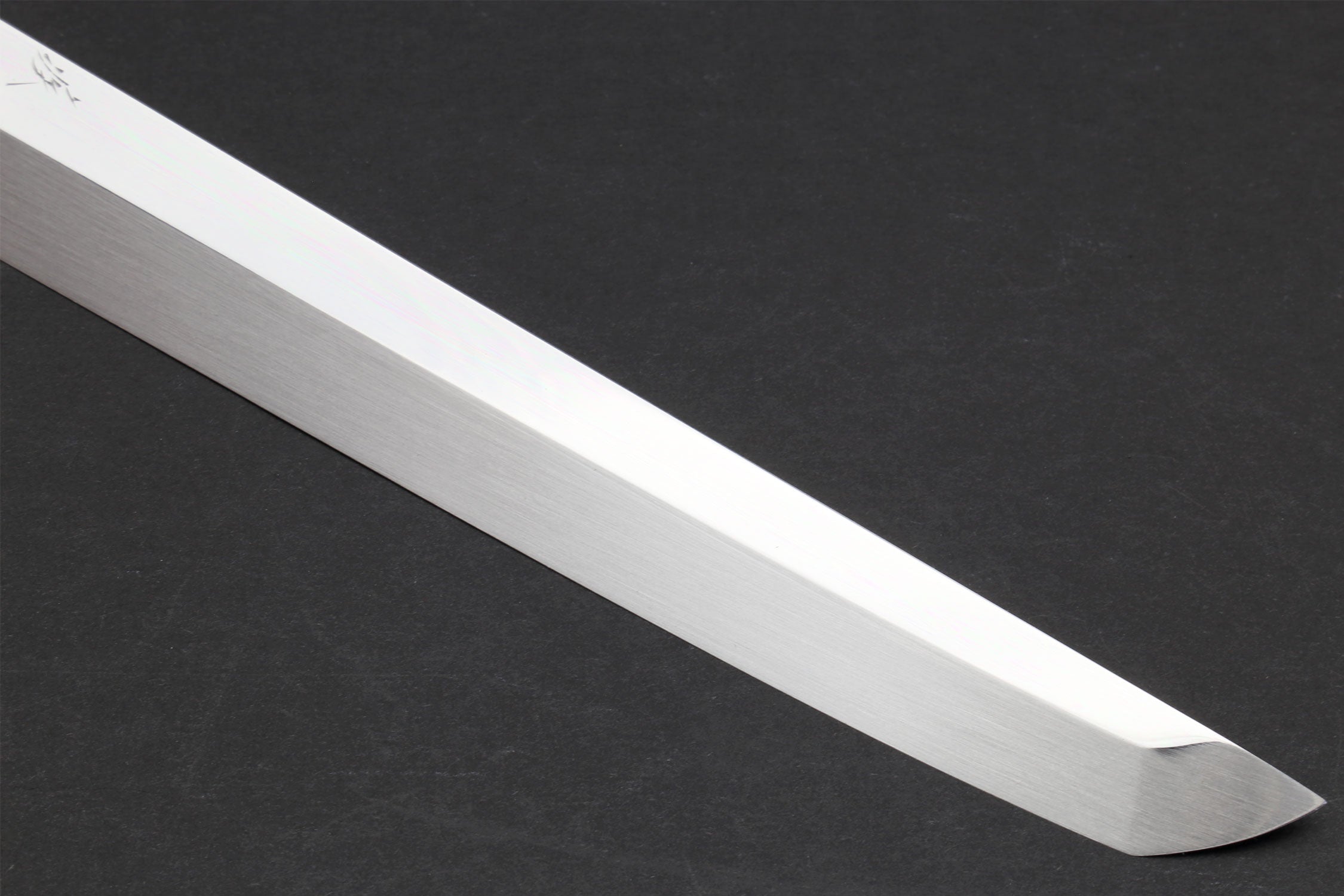 Mirror-finished sushi knife blade with pointed tip and smooth edge.