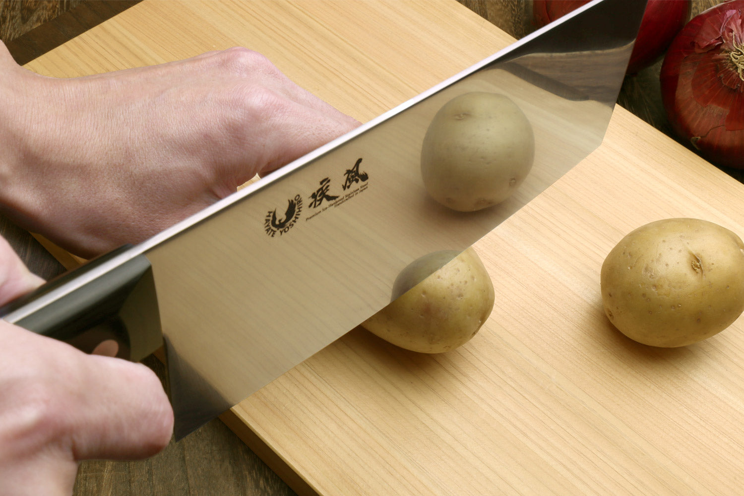 Chinese-style chef cleaver knife slicing vegetables with black handle