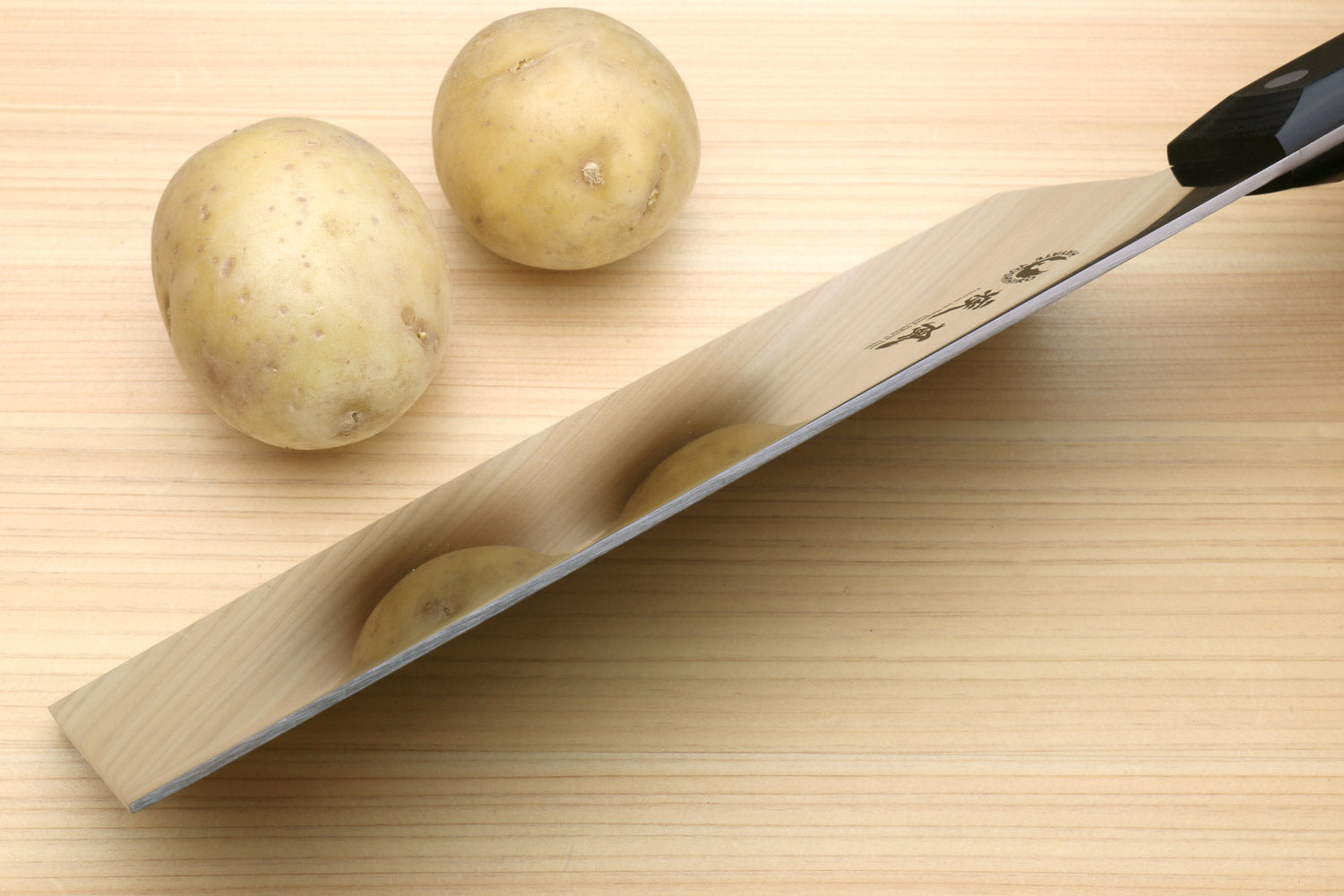 Chinese-style chef cleaver knife with black handle and beveled steel edge