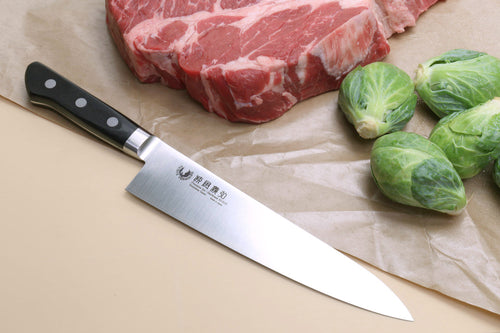 Stain-resistant gyuto knife with black handle and silver blade, full length view