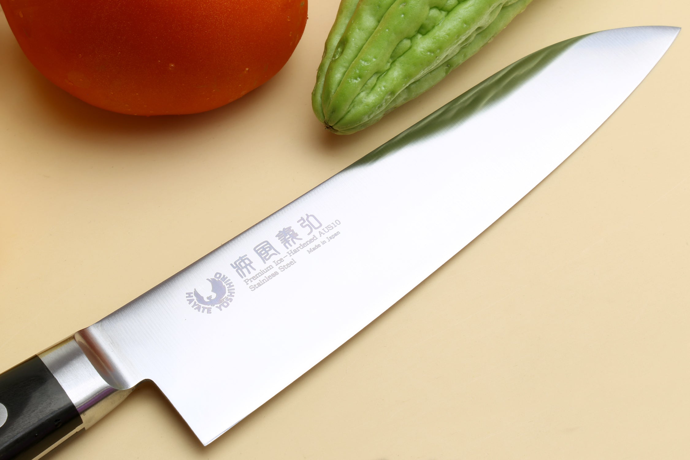 Santoku chef’s knife blade close-up with engraved Japanese characters on stainless steel
