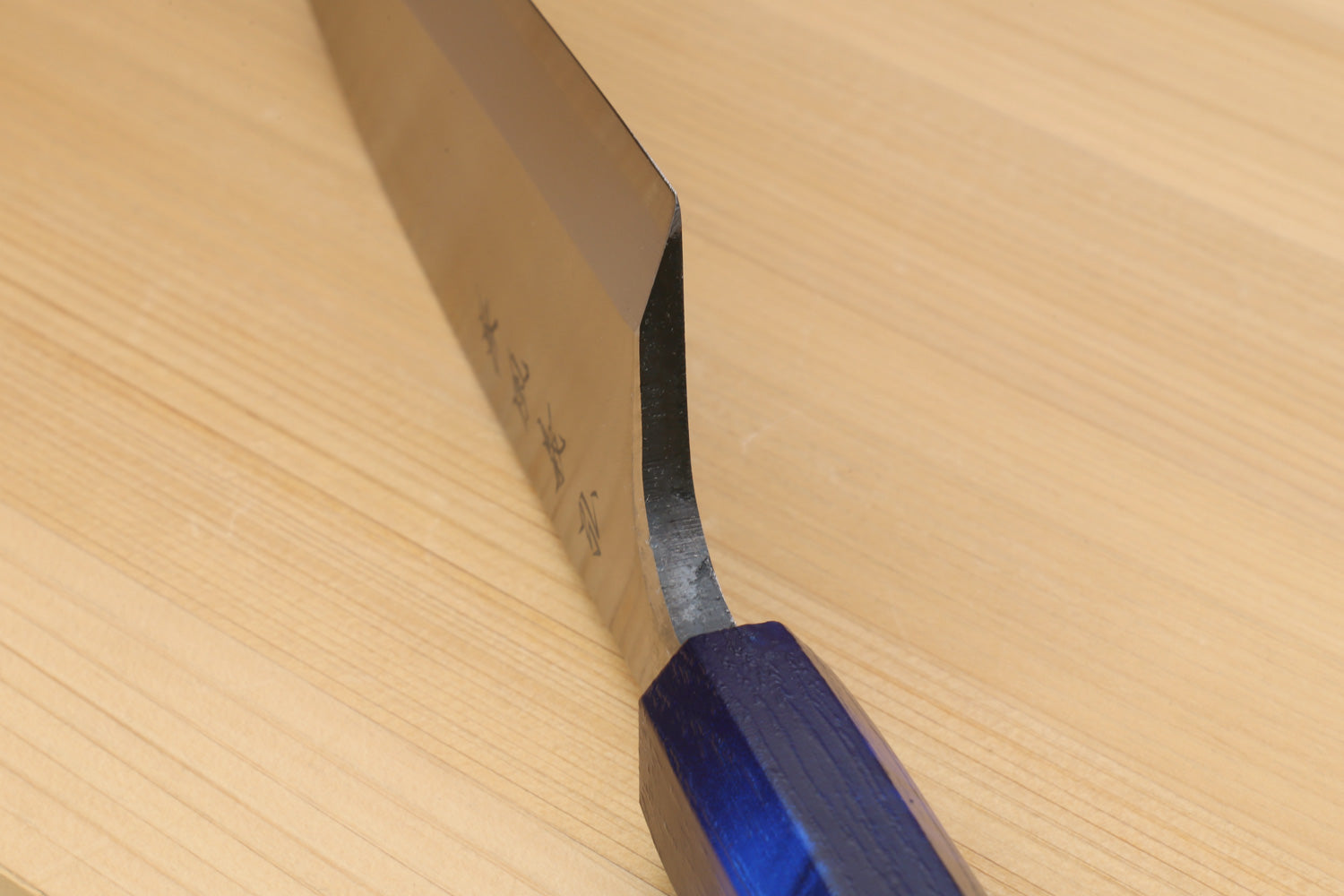 Japanese deba knife tip and dark blue handle detail