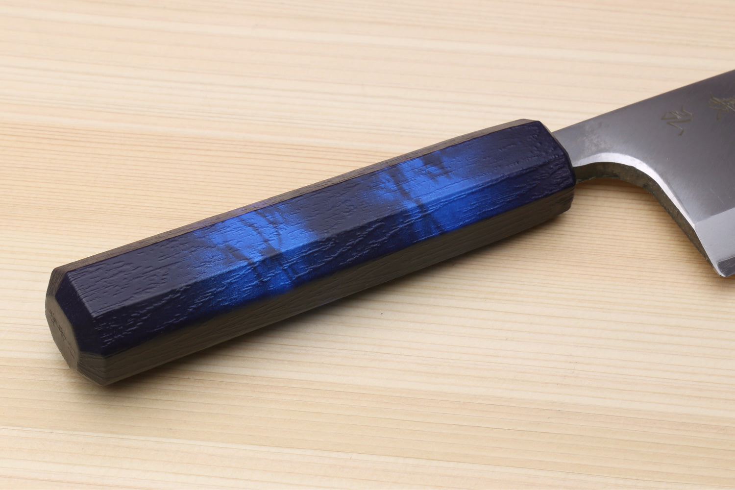 Japanese deba knife handle close-up with stainless blade