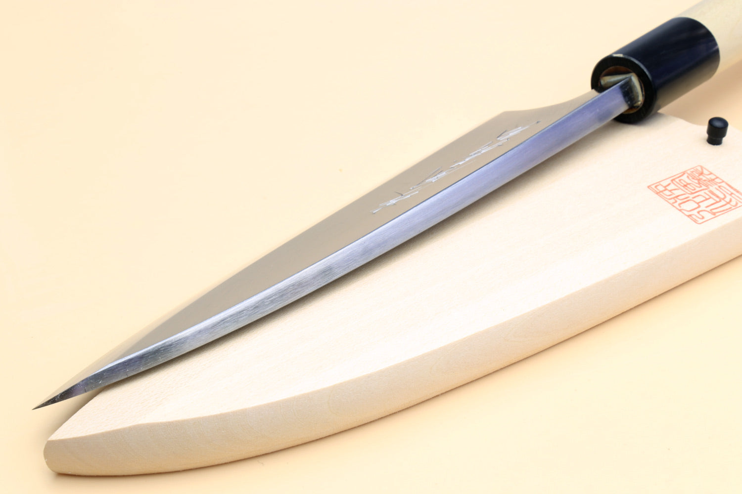 Long deba fish fillet knife with pointed white blade and light magnolia handle, black collar