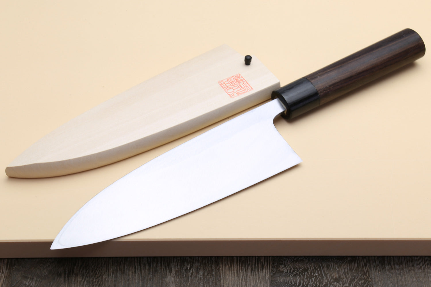 Deba fish fillet knife with white steel blade and dark rosewood handle, tip down
