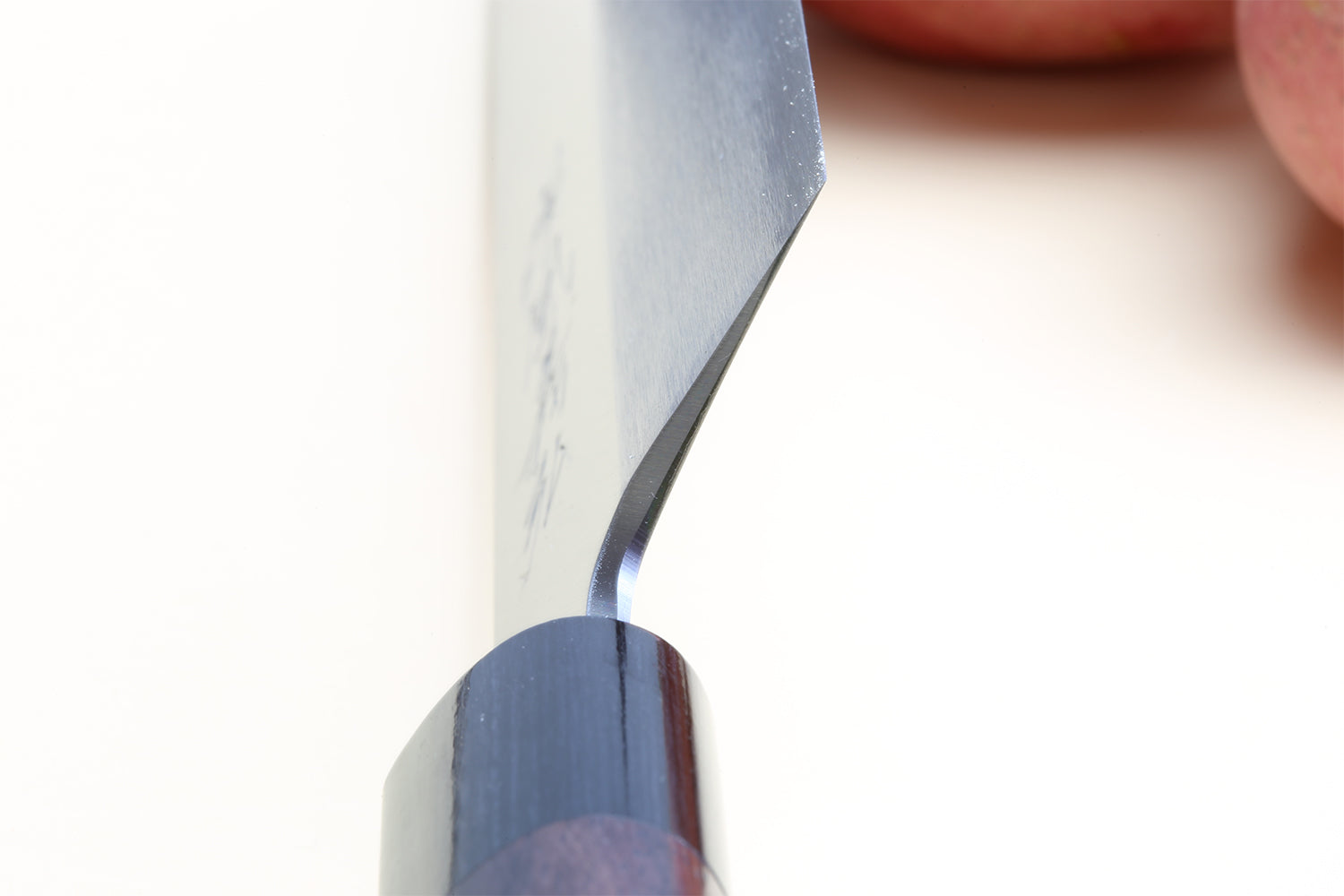 Traditional Japanese vegetable knife close-up of white steel blade tip and edge