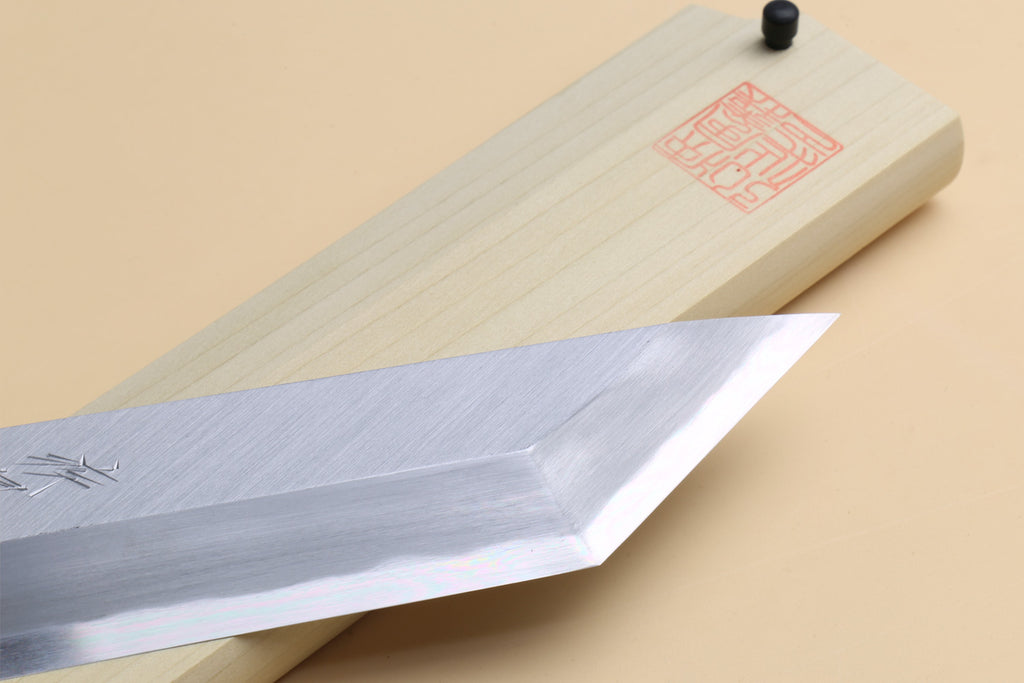 Edosaki eel filet knife close-up of pale steel blade on light wood saya