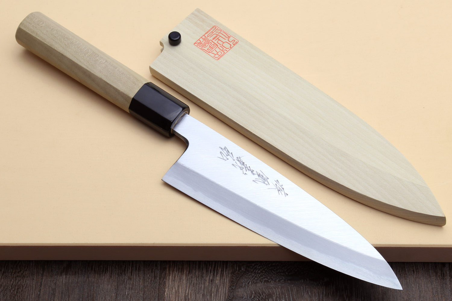 Fish fillet chef knife with light wood handle, dark bolster, and silver blade