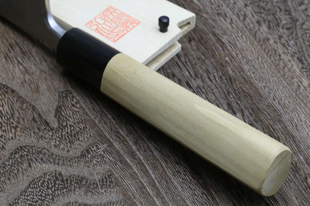 Japanese chef knife close-up with light wood handle and silver blade root