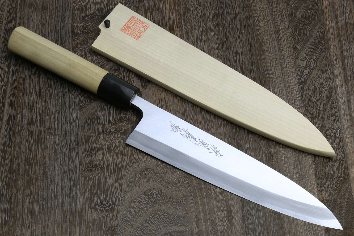 Sashimi filet knife with light wood handle, silver blade, and black bolster