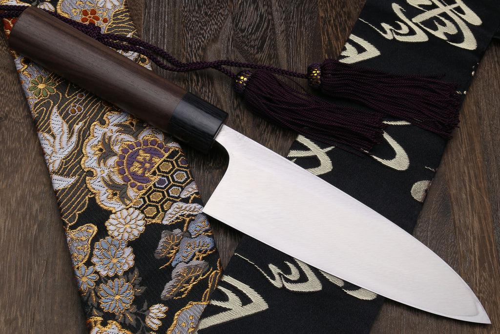 Left-handed deba fish fillet knife with white blade and dark shitan handle, side view