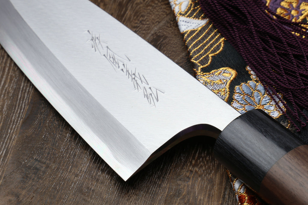 Left-handed deba fish fillet knife, white blade close-up with dark handle