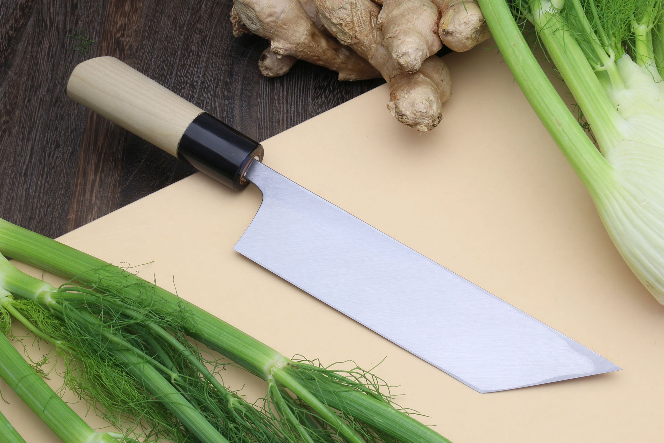 Filet knife with light wood handle, black bolster, and long silver blade