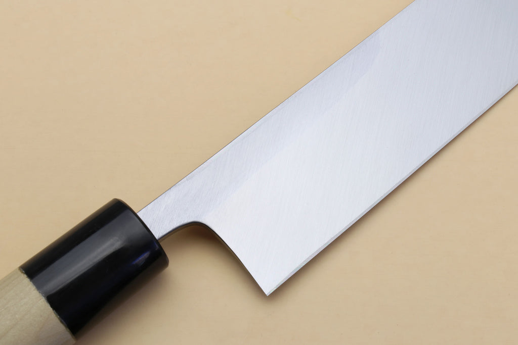 Silver blade section with pointed tip and black bolster on light wood handle