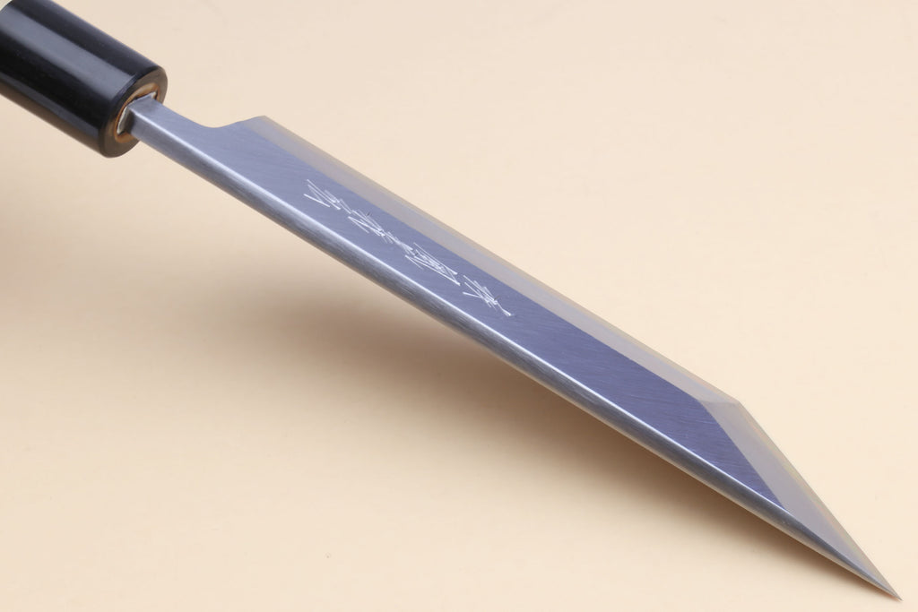 Long silver filet blade with fine etched text and pointed tip