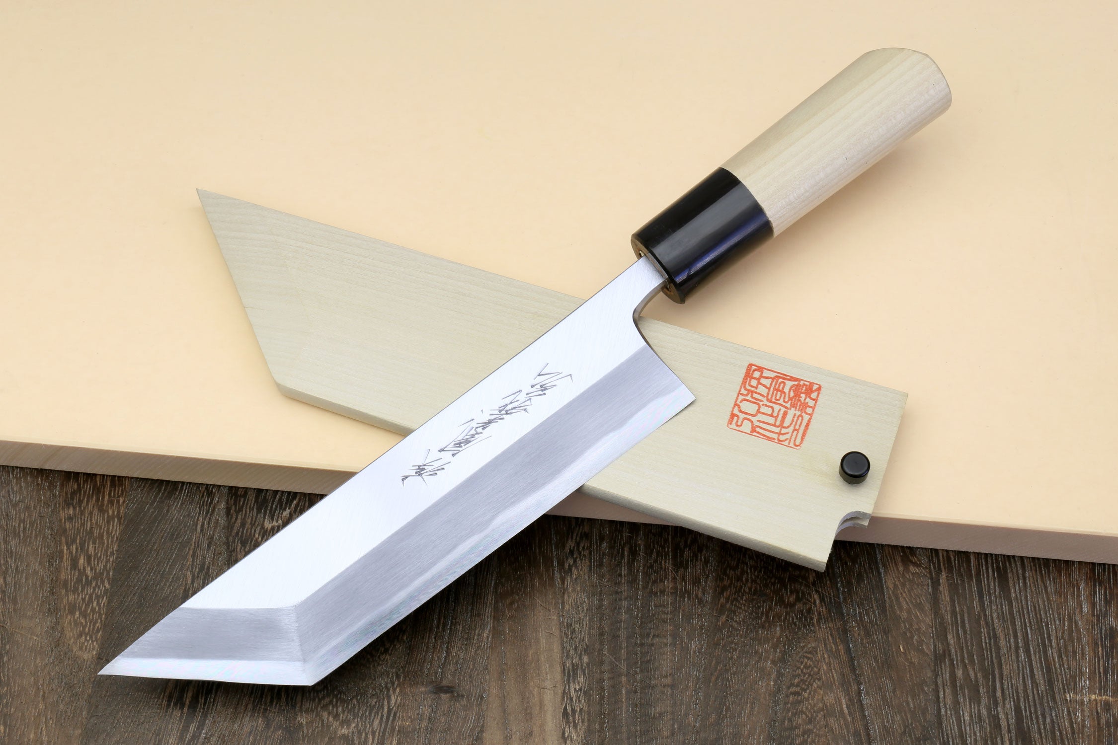 Filet knife with silver blade and light wood handle with black bolster