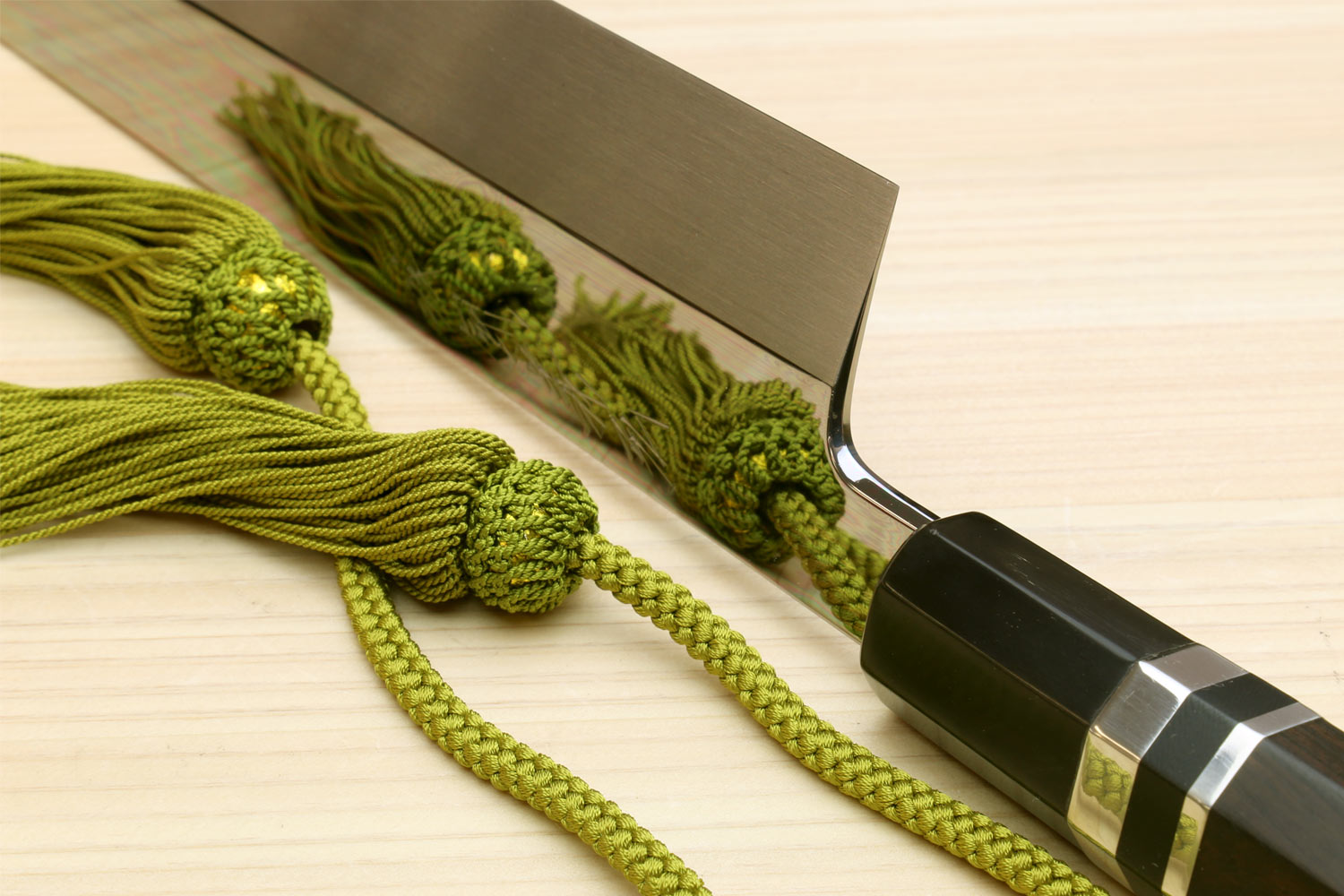 Mirror-polished Japanese vegetable knife with dark handle and silver ring, straight blade