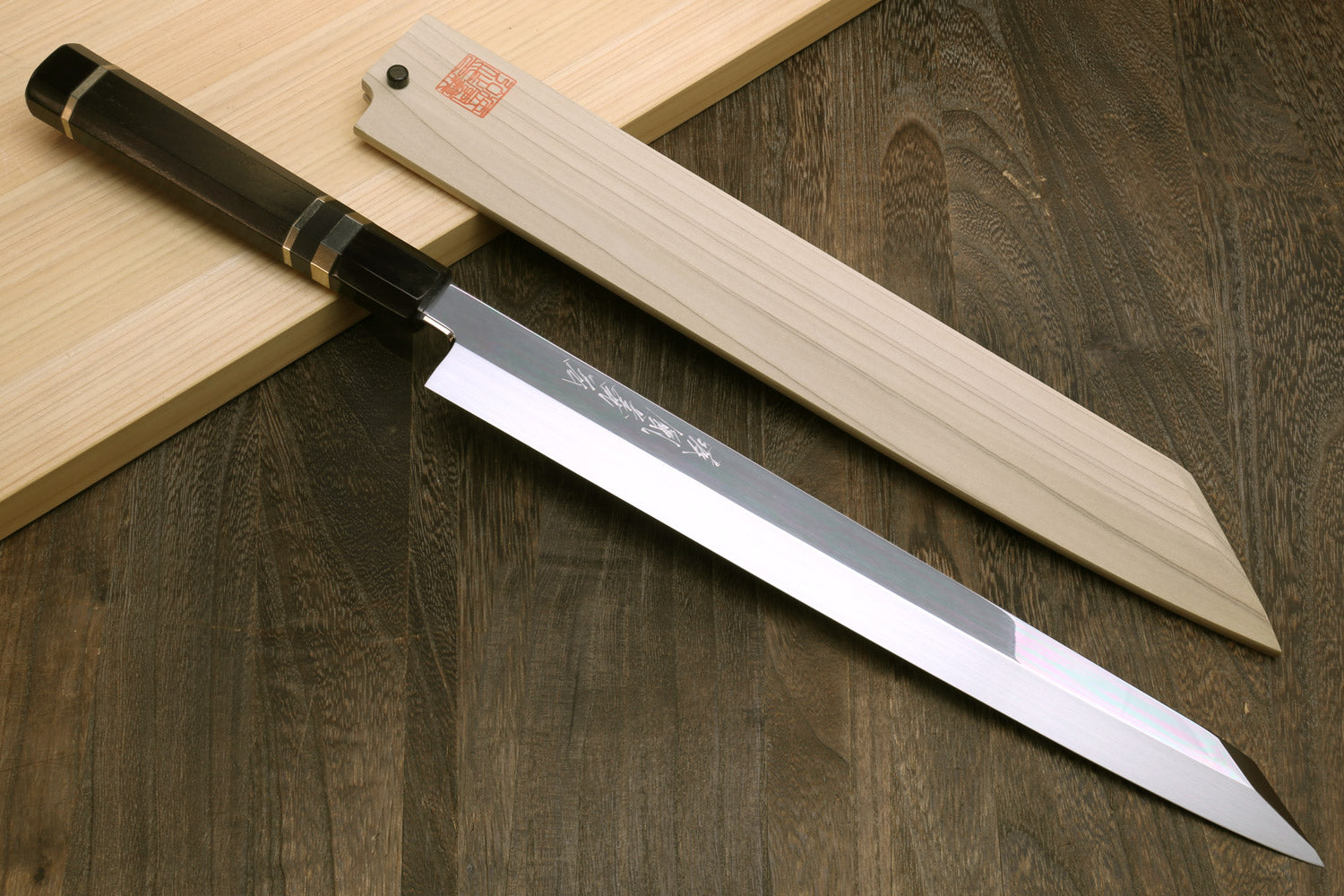 Yanagi-kiritsuke sushi knife with mirror-finished blade and wooden saya