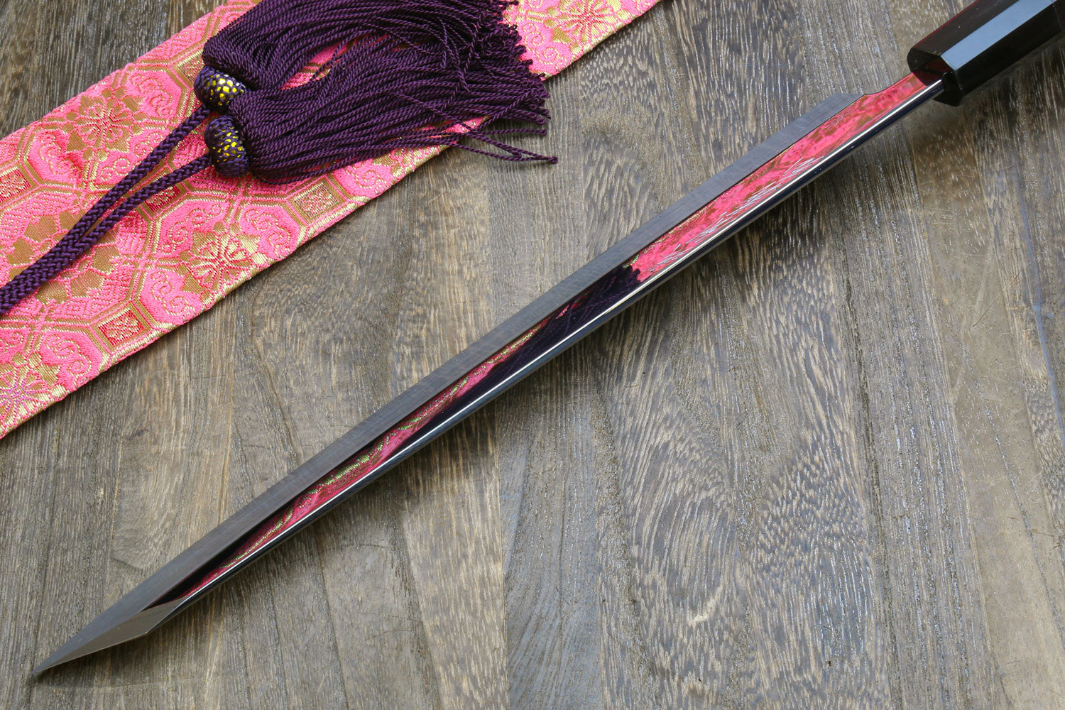 Japanese sushi knife with mirror-finished blade and black handle