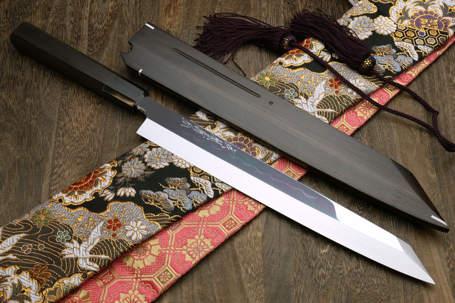 Japanese sushi knife with mirror-finished blade and matching black saya