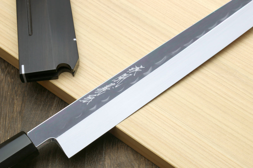 Sashimi knife with engraved blade pattern and dark saya