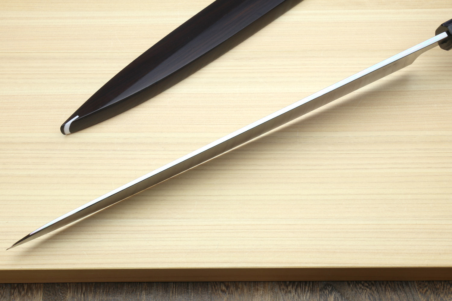 Sashimi knife with mirror-finished stainless blade and dark handle