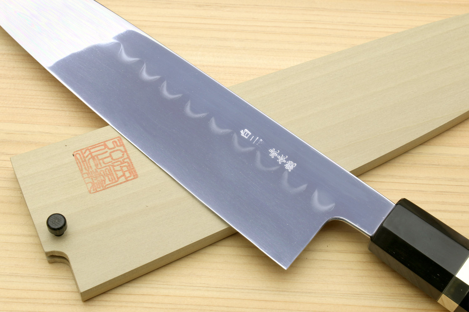 Japanese chef knife with wavy hamon blade and ebony handle with silver ring