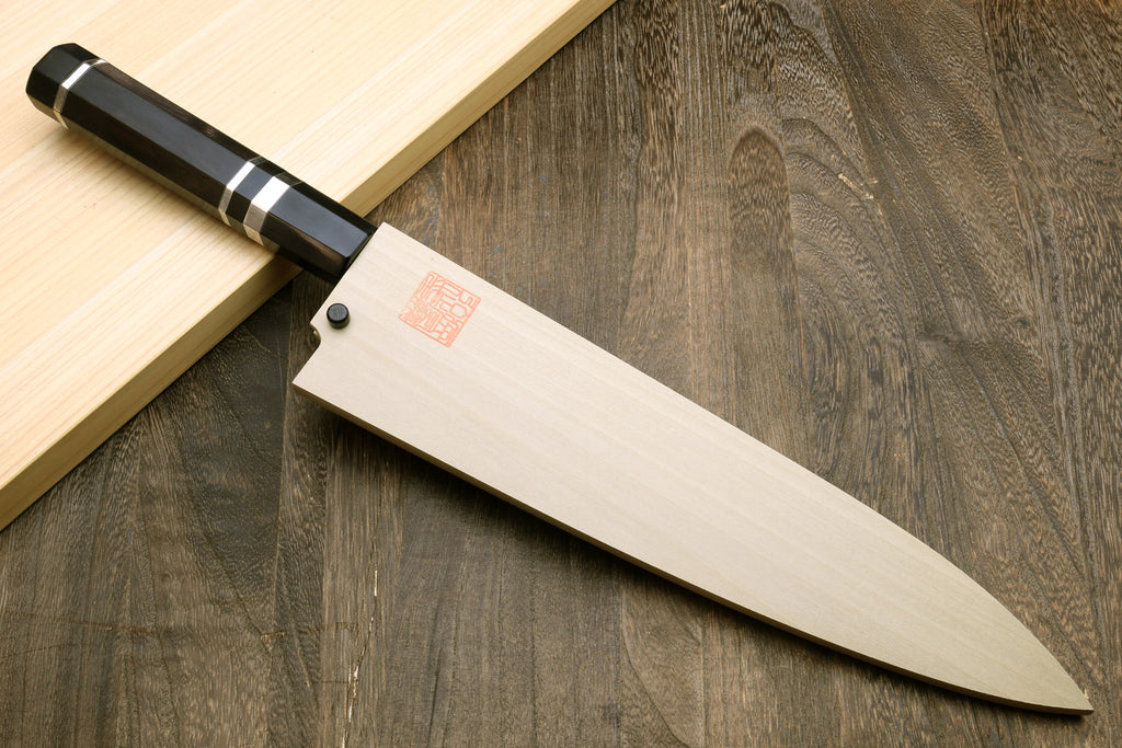 Japanese chef knife with white-striped ebony handle and mirror-polished blade