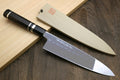 Japanese chef knife with mirror-polished blade, wavy hamon, and black handle