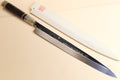 Japanese kitchen knife with dark handle and silver ring ferrules