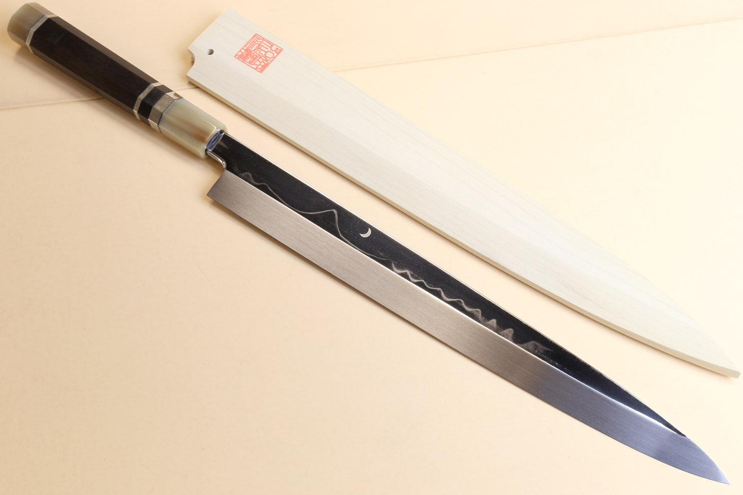 Japanese kitchen knife with dark handle and silver ring ferrules