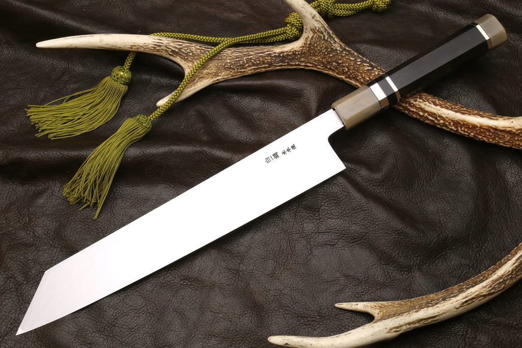 Kiritsuke knife with horn sheath, ivory handle, and green cord tassels.