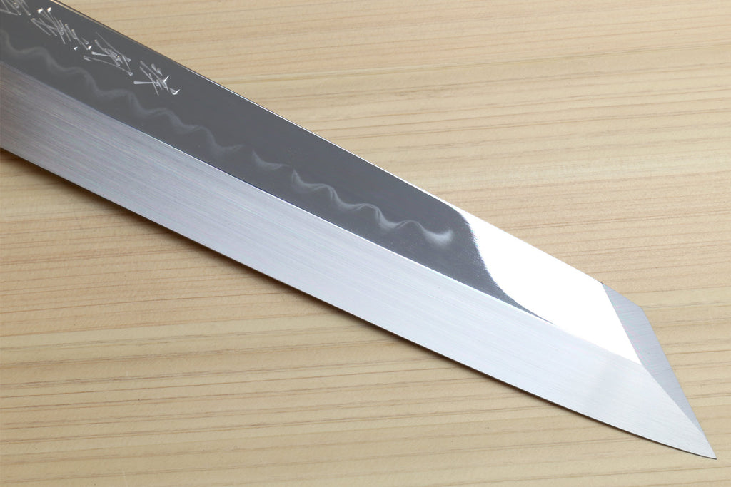 Japanese kitchen knife blade close-up with wavy hamon pattern