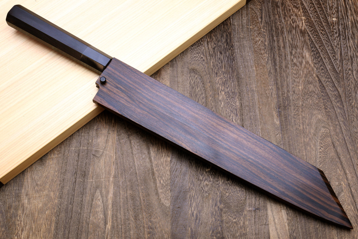 Ebony knife saya and dark handle with partial blade visible