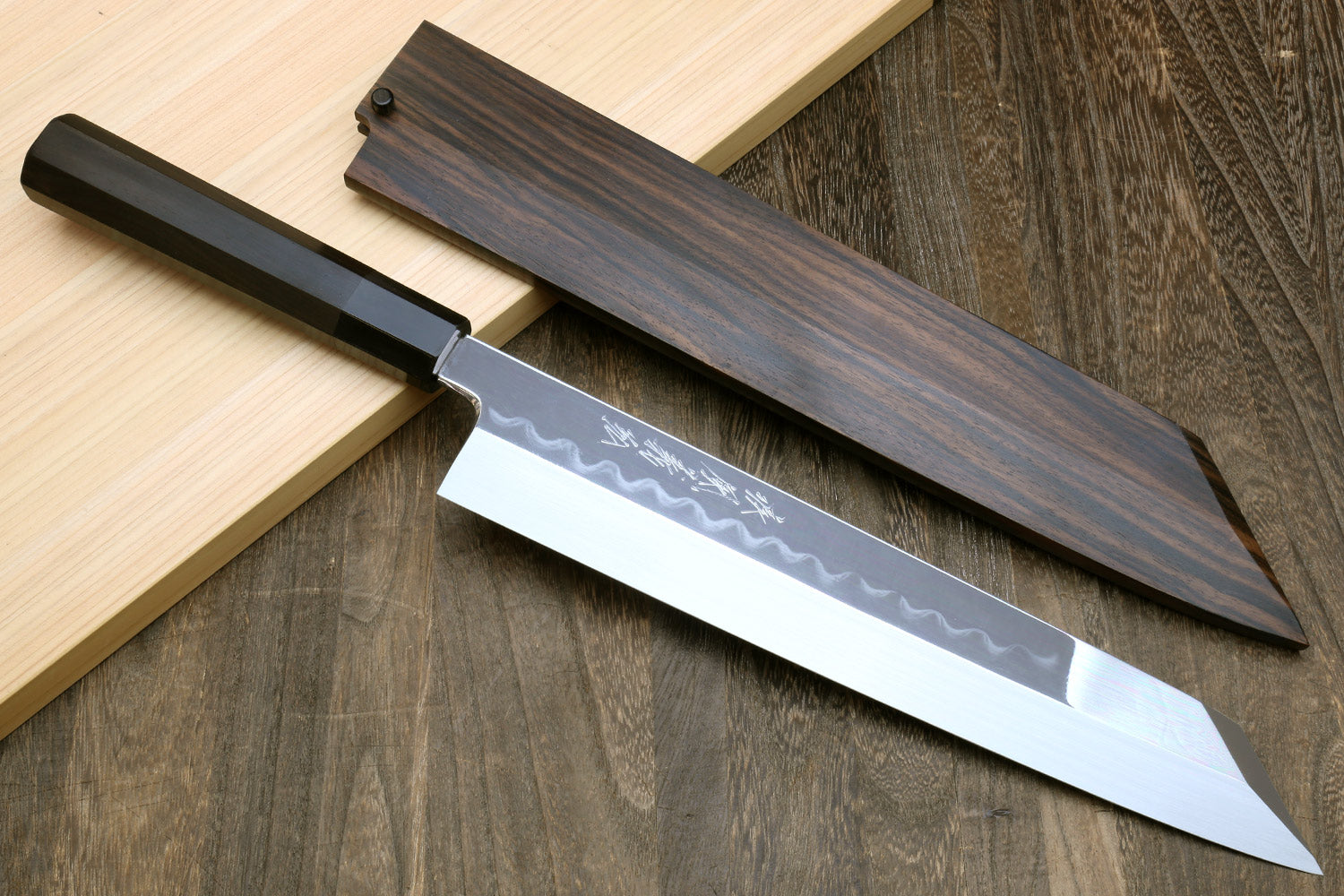 Japanese kitchen knife with white blade and ebony handle in saya