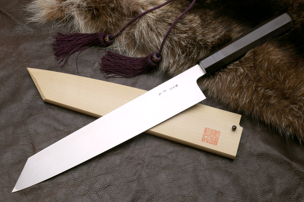 Kiritsuke knife with saya and mirror-polished blade, tip and spine visible