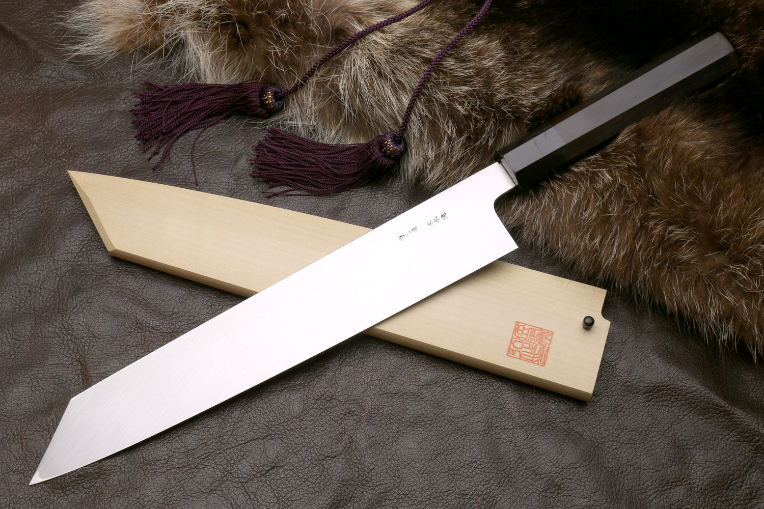 Kiritsuke knife with saya and mirror-polished blade, tip and spine visible