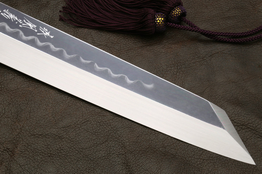Kiritsuke knife with mirror-polished blade and wavy hamon pattern detail