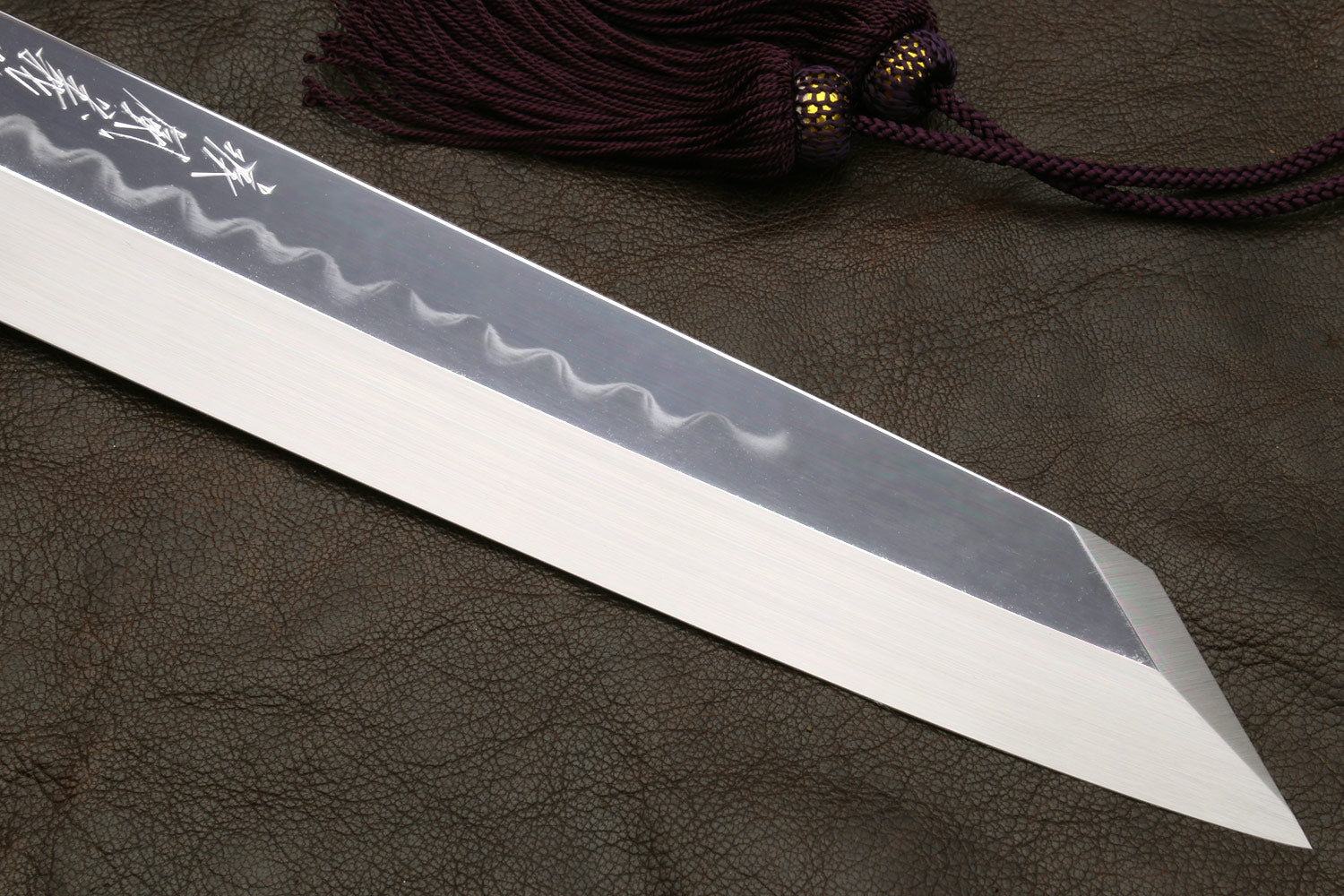 Kiritsuke knife with mirror-polished blade and wavy hamon pattern detail