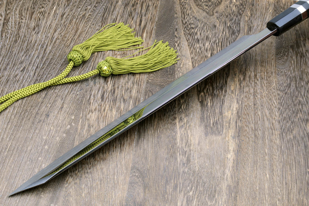 Mirror-finished Japanese knife with dark handle, green cord, and black cloth wrap